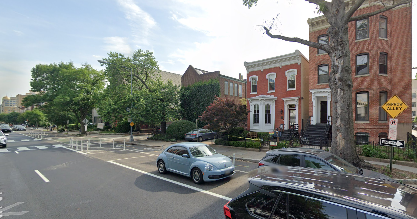 Image of a photograph of a row house next to a street.